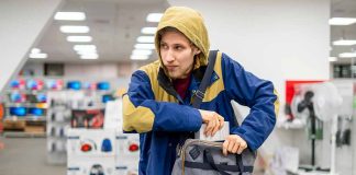 Person in store hiding something in a bag