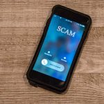Incoming call labeled SCAM on smartphone screen