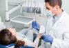 Dentist examining a patient in a dental chair