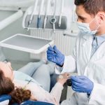 Dentist examining a patient in a dental chair