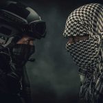 Two masked figures face each other dramatic lighting