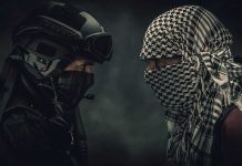 Two masked figures face each other dramatic lighting