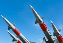 Missiles pointing upwards against a clear sky