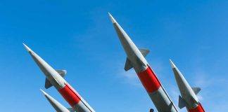 Missiles pointing upwards against a clear sky