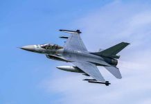 Jet fighter flying through clear blue sky