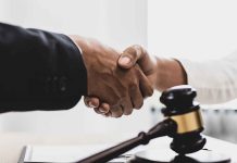 Handshaking near a gavel on desk
