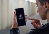 Person using TikTok app on smartphone