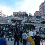 People at a collapsed building after an earthquake