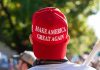 Red Make America Great Again hat on person head
