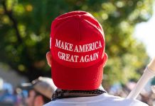Red Make America Great Again hat on person head
