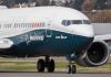 Boeing 737 MAX airplane on runway.