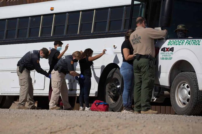 1973414852 featured image Border patrol officers investigating people near a bus