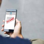 Person reading a scam message on a smartphone