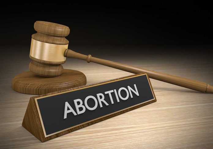 317138369 featured image Gavel and sign reading "Abortion" on a wooden surface.