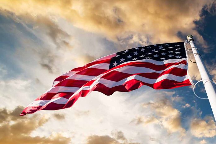 American flag waving against a cloudy sky