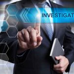 Man in suit pointing at Investigation text
