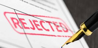 Rejected stamp on a document with pen