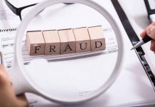 Fraud blocks under magnifying glass on invoices