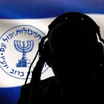 Silhouette with headphones, Mossad emblem in background.