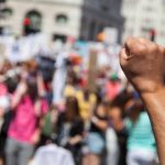 Raised fist in front of a crowd