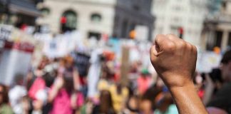 Raised fist in front of a crowd