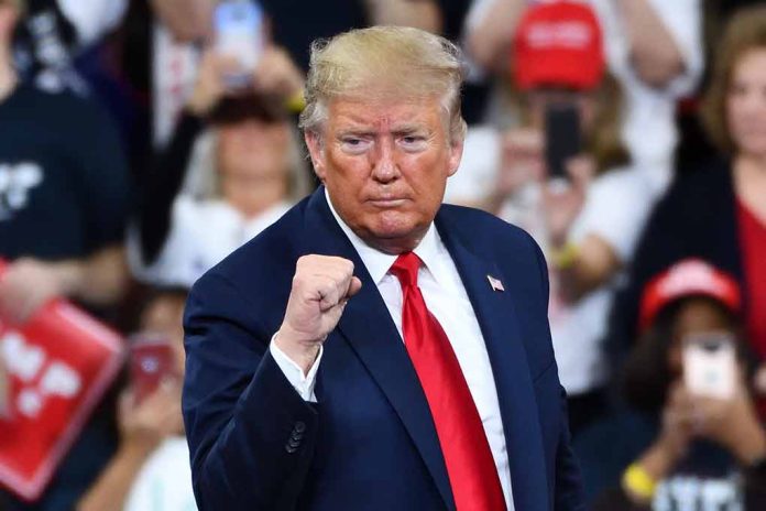 1585235176 featured image Man in suit making a fist gesture at rally