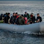 People on a packed raft in open water