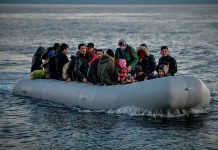 People on a packed raft in open water