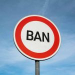 Sign with word BAN against clear sky