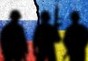 Silhouetted soldiers with Russian and Ukrainian flag backgrounds