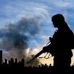 Silhouette of armed figure with smoky city skyline