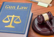Gun Law book and gavel on wooden desk