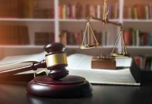 Gavel law book and scales in a library