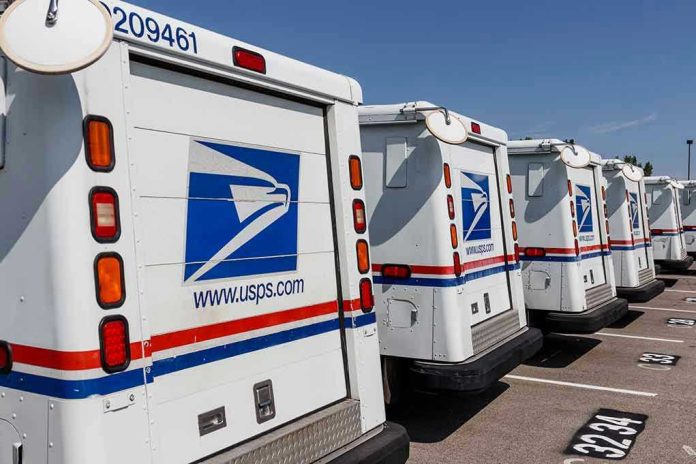Row of USPS mail trucks parked in lot