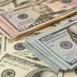 Stacks of various dollar bills