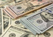 Stacks of various dollar bills