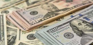 Stacks of various dollar bills
