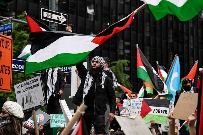 Protesters with flags and signs, one holding a megaphone