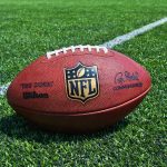 NFL football on a green field.