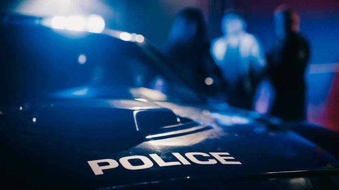 2232056701 Police car with blurred figures in the background
