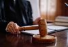 Judge holding gavel in courtroom