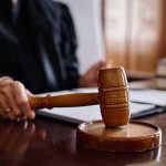 Judge holding gavel in courtroom