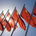 Red flags with yellow stars on flagpoles