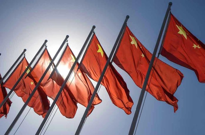 325058183 Red flags with yellow stars on flagpoles