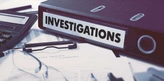 Documents and binder labeled Investigations on desk