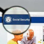 Magnifying glass focusing on Social Security Administration webpage