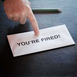 Envelope with YOU ARE FIRED and pointing finger