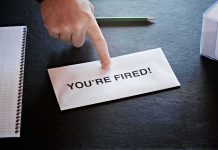 Envelope with YOU ARE FIRED and pointing finger