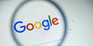 Google logo viewed through a magnifying glass
