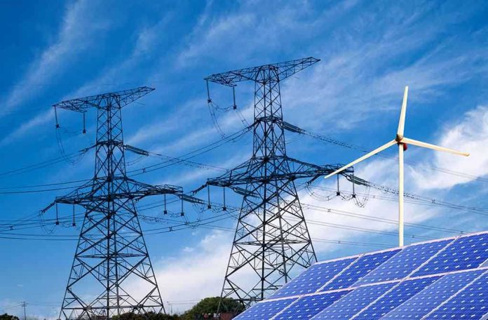 shutterstock_138865700.jpg Solar panels and a wind turbine with power lines against a blue sky